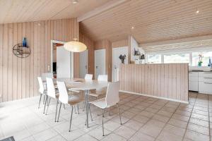 a dining room with a table and white chairs at 14233-Grevinge-Grevinge-Kanalvej-95 in Grevinge +10 photos