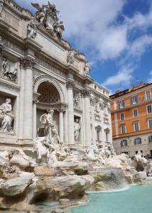 a building with a fountain in front of it at Hotel Caravita in Rome
