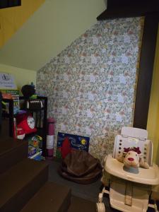 a childs room with a baby crib with a toy at Carl and Ellie Home in Bangkok +29 photos