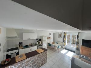 a kitchen with white appliances and a table in it at Tikazla - Séjour détente in La Turballe