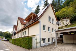 a white house with a brown roof at Ferienwohnung Annette in Gomadingen