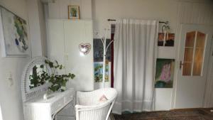Habitación con 2 sillas y armario blanco en Ferienwohnung Firnhaber - Nieder Seifersdorf Oberlausitz, en Nieder Seifersdorf 40 fotos más