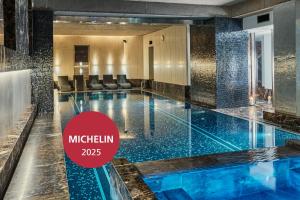 a pool in a hotel lobby with a mitzlin sign on it at Hotel Monopol in Wrocław