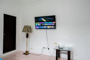 une pièce avec une télévision sur un mur blanc dans l'établissement Tinian Island Haven, Sapphire Unit Apartment, 