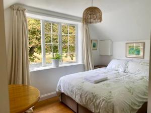 a bedroom with a bed and a window at Cotswolds Retreat in Tewkesbury