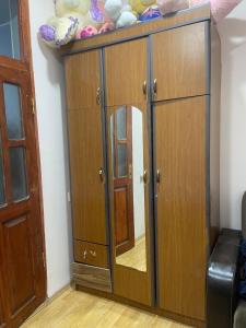 a wooden cabinet with a mirror in a room at Lucky Nest in Baku +4 photos