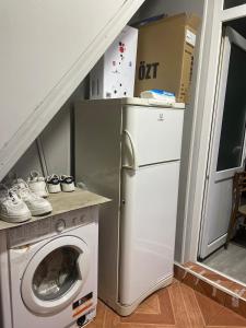 a laundry room with a washing machine and a washer at Lucky Nest in Baku