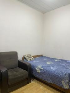 a bed and a couch in a room at Lucky Nest in Baku