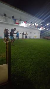 a group of people playing a game of frisbee on a field at Toska homes in Mullini i Danit