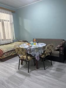 a room with a table and chairs and a bed at Lucky Nest in Baku