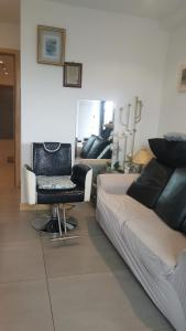 a bedroom with a bed and a chair and a couch at Jadwin Beautiful Room Share toilet 2 people in London