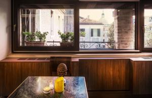 a room with a table and a window with a view at Ai Due Fanali in Venice
