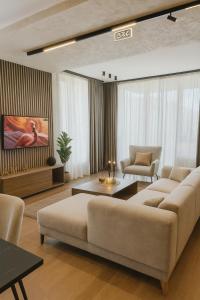 a living room with two couches and a tv at Belgrade Waterfront Nostra Casa in Sajmište