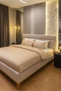 a bedroom with a large bed with white pillows at Belgrade Waterfront Nostra Casa in Sajmište