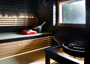 a sauna with a bench and a window at Riihikarhu Spa A in Muurame +15 photos
