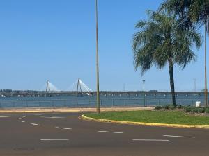 an empty street with a palm tree and a bridge at Departamento Soles in Posadas