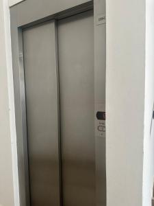 a pair of metal elevator doors in a building at Departamento Soles in Posadas