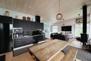 a large kitchen with a wooden table in it at Riihikarhu Spa A in Muurame