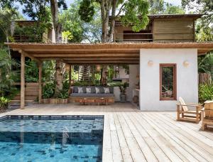 a house with a pool in front of a house at VILA 335 Trancoso in Trancoso