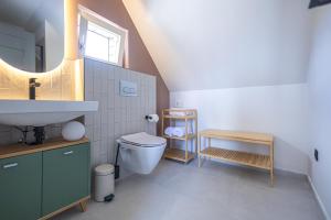 a bathroom with a sink and a toilet at Pipacs és Buborék in Balatonudvari +37 photos