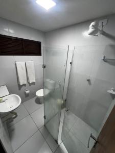 łazienka z przeszkloną kabiną prysznicową i umywalką w obiekcie Residencial Sol - Cidade alta w mieście Natal +5 zdjęć