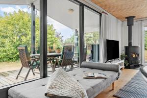 a living room with a couch and a fireplace at 8003-Knebel-Skodshovedgard-41 in Knebel