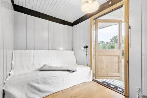 a bedroom with a bed and a window and a door at 8003-Knebel-Skodshovedgard-41 in Knebel