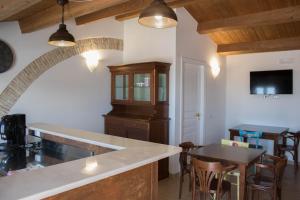 a kitchen with an archway and a table and chairs at Residenza delle Grazie in Miglionico