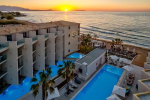 an aerial view of the hotel and the ocean at sunset at White Olive Elite Rethymno in Sfakaki