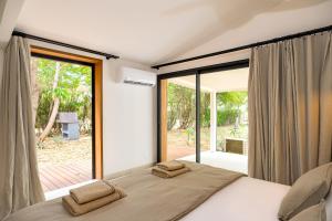 En eller flere senge i et værelse på Villa d exception au charme créole à l Ermitage