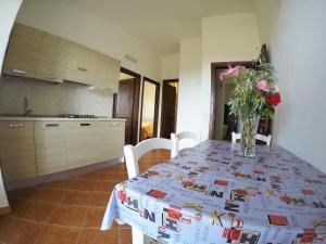 a kitchen with a table with a vase of flowers on it at Residence Pantaleo in Ricadi