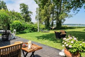 a wooden deck with a table and flowers on it at 30116-Odder-P-Baatrupsvej-47 in Beder