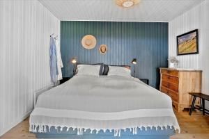 a bedroom with a large bed and a blue wall at 30116-Odder-P-Baatrupsvej-47 in Beder