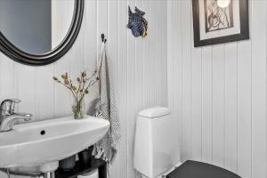 a bathroom with a sink and a toilet and a mirror at 30116-Odder-P-Baatrupsvej-47 in Beder +21 photos