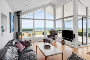 a living room with a couch and a tv and a large window at 30012-Malling-Peter-Eriksens-Vej-1 in Malling
