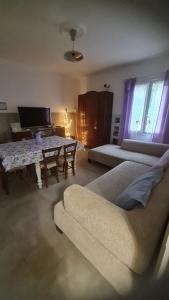 a living room with a couch and a table at Tana della Lavanda in Montefiorino