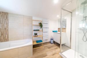 a bathroom with a tub and a shower at Gîte Milena - SPA - Puy duFou - Grande capacité in Les Épesses +48 photos