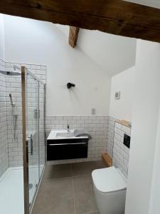 a bathroom with a sink and a toilet at Threshing Barn- Modern 5 Bed, 10 person, Barn Conversion in a Rural Location with Great Access in Silkstone