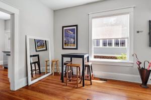 a dining room with a table and chairs and a window at Old City Charm l Historic l Walk to St George in Saint Augustine +36 photos