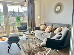 a living room with a couch and a table at fewo1846 - Strandresidenz Wassersleben KuestenNest - luxuriöses Studioapartment mit Balkon und Meerblick in Harrislee