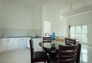 a kitchen and dining room with a table and chairs at Caravan holiday homes Vythiri in Vythiri