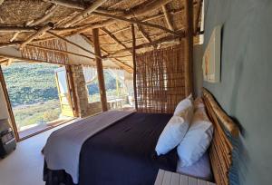 a bedroom with a bed with a large window at Oudrif Strawbale Retreat in Clanwilliam +59 photos