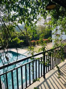 a view from a balcony of a swimming pool at Caravan holiday homes Vythiri in Vythiri