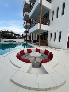 a patio with a table and chairs and a pool at Jumeirah Malindi Hotel in Malindi