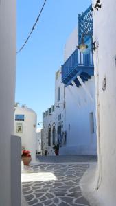 a group of white buildings with blue balconies on them at Akro Astypalea in Astypalaia