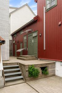 a red building with a green door on the side of it at Central studio apartment in Tromsø