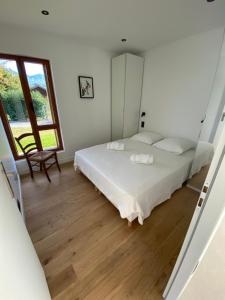 een slaapkamer met een bed en een groot raam bij Chalet Morets in Saint-Gervais-les-Bains