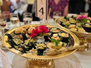 a plate of food on a table with plates of food at The Sun Hotel in Long Bình