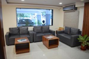 a living room with a couch and a table at Hotel Skyview in Kondapur