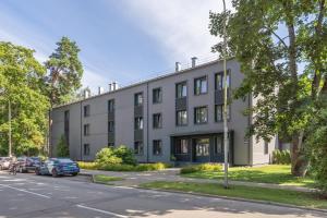 an apartment building on the corner of a street at Premium One Bedroom Apartment Dzintari Beach & Park in Jūrmala